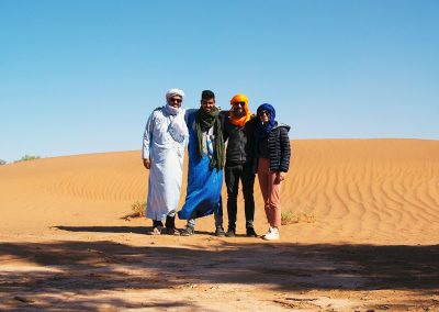 Camel Men and clients in Sahara desert